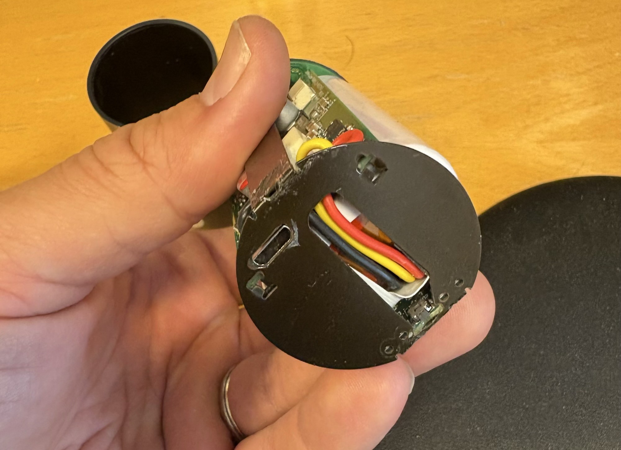 The opened battery front panel with its USB charging circuit and wiring exposed